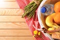 Picnic wicker basket with food on wood table top