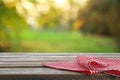 Picnic wooden table with checkered red napkin