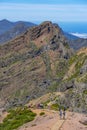 Pico do Areeiro mountain in Madeira Island with people walking on the PR1 trail towards Pico Ruivo. Royalty Free Stock Photo