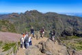 Pico do Areeiro mountain in Madeira Island with people walking on the PR1 trail towards Pico Ruivo. Royalty Free Stock Photo