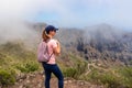 Pico Verde - Woman with backpack enjoying view on Teno mountain range near Masca village, Tenerife, Canary Islands, Spain, Royalty Free Stock Photo