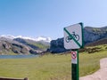 PICOS DE EUROPA NATIONAL PARK, SPAIN - MAY 25, 2019:Bikes and drones prohibited sign near Ercina lake of Covadonga in the Picos de Royalty Free Stock Photo