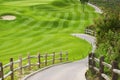 Picteresque green golf field with a fence Royalty Free Stock Photo