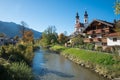 Pictorial autumn scenery, Aschau im Chiemgau, church with twin tower and prien river, tourist resort upper bavaria