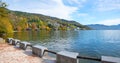 Pictorial lake Mondsee, lakeside promenade with view to autumnal shore and mountains