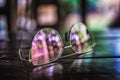 Pictrure of sun glasses on the wooden table with colorfull reflections. Royalty Free Stock Photo