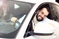 Adult couple choosing new car in showroom Royalty Free Stock Photo