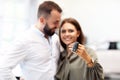 Adult couple choosing new car in showroom Royalty Free Stock Photo