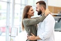 Adult couple choosing new car in showroom Royalty Free Stock Photo