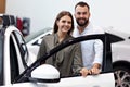 Adult couple choosing new car in showroom Royalty Free Stock Photo