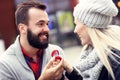 Adult man giving engagement ring to beautiful woman Royalty Free Stock Photo