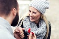Adult man giving engagement ring to beautiful woman Royalty Free Stock Photo