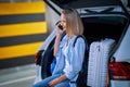 Adult woman tourist in underground airport parking lot