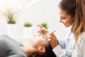 Adult woman having eyelash extension in professional beauty salon Royalty Free Stock Photo