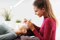 Adult woman having eyelash extension in professional beauty salon