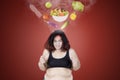 Angry fat woman hating healthy food Royalty Free Stock Photo