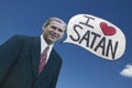 Picture of anti-Bush political rally in Tucson, AZ with a sign saying President George W. Bush Loves Satan in Tucson, AZ Royalty Free Stock Photo