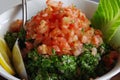 Picture of an Arabic salad, fresh tabouleh made of parsley, tomatoes, lemon juice, mint.