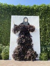 Picture of arabic woman covered by plants and flowers, amazing colorful park, Miracle garden in Dubai