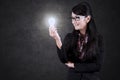 Asian businesswoman looking at a bright bulb