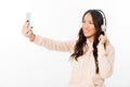 Asian cheerful woman listening music make selfie by mobile phone.