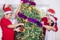 Asian family decorating a Christmas tree at home Royalty Free Stock Photo