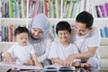 Asian family reading books in the library Royalty Free Stock Photo