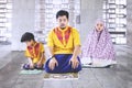 Asian family doing Salat in the mosque
