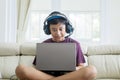 Asian preteen boy playing online games on laptop Royalty Free Stock Photo