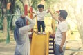 Baby girl playing with her parents in the park