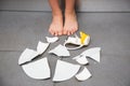 Picture back and white of a child making a dish and  glass of water broken  on the kitchen floor. The concept is dangerous for the Royalty Free Stock Photo