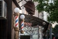 Typical American barbers pole seen in front of a barber shop. This pole is a vintage sign indicating presence of male hairdresser Royalty Free Stock Photo