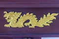 Beautiful golden dragon crafted pattern on wooden showcase. Royalty Free Stock Photo