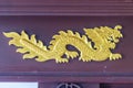 Beautiful golden dragon crafted pattern on wooden showcase. Royalty Free Stock Photo