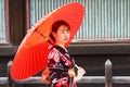 Japanese Geisha walking in a park during Cherry blossom festival