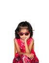 Picture of beautiful liitle girl in red dress wearing sun glasses sitting on chair