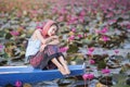 Beautiful woman with lotus flower at the red lotus sea Royalty Free Stock Photo