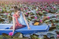 Beautiful woman with lotus flower at the red lotus sea Royalty Free Stock Photo