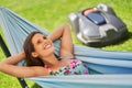 Pretty woman Relaxing In Hammock with automower in background