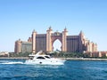 Picture of a beautiful yacht passing in front of the Atlantis the famous 5 stars hotel located on Palm Jumeirah in Dubai. Royalty Free Stock Photo