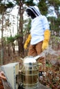 Bee keeper walking past the bee smoker