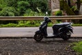 Picture of black color scooter parked at road side in India Royalty Free Stock Photo