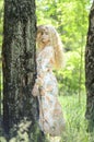 Picture of blonde girl with curly hair in the forest Royalty Free Stock Photo