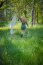 Picture of blonde girl with curly hair in the forest Royalty Free Stock Photo