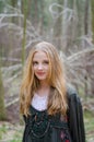 Picture of blonde girl standing in the forest Royalty Free Stock Photo