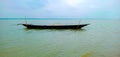 Picture of a boat in the middle of a beautiful river.