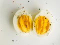 A picture of a boiled egg, divided longitudinally, with some spices Royalty Free Stock Photo