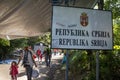 Refugees walking next to the border sign on Serbia Croatia boundary in Berkasovo Bapska, on the Balkans Route