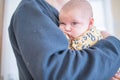 Baby Girl with Bored Expression in the Arms of Her Granddad