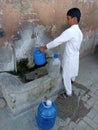 picture of a boy filling the water in pakistan